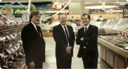 An Image of three persons stand in store